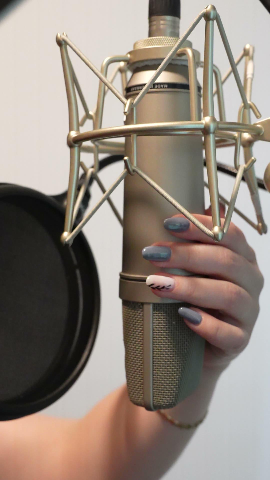 Engineer positioning the studio's large-diaphragm condenser microphone