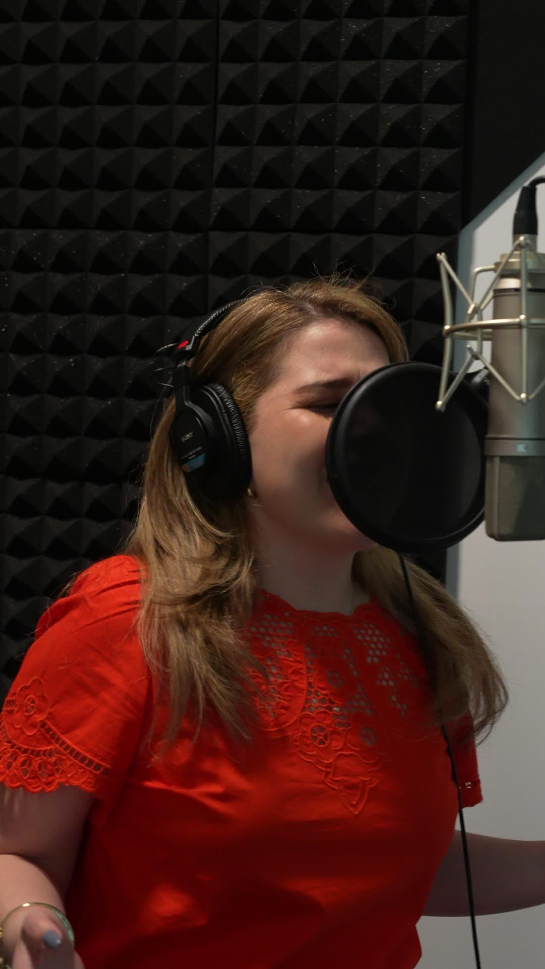 A vocalist tracking into a large-diaphragm condenser in the Hope Is Born vocal booth